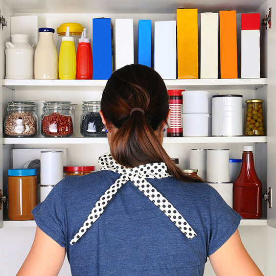 woman standing in front of kitchen cabinet