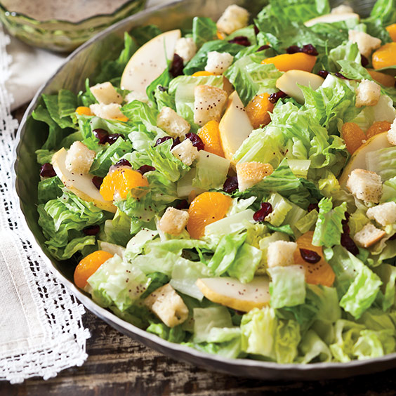 This Romaine Holiday Salad is a tasty combination of dried cranberries, mandarin oranges, pears, homemade crotons, and Romaine lettuce.